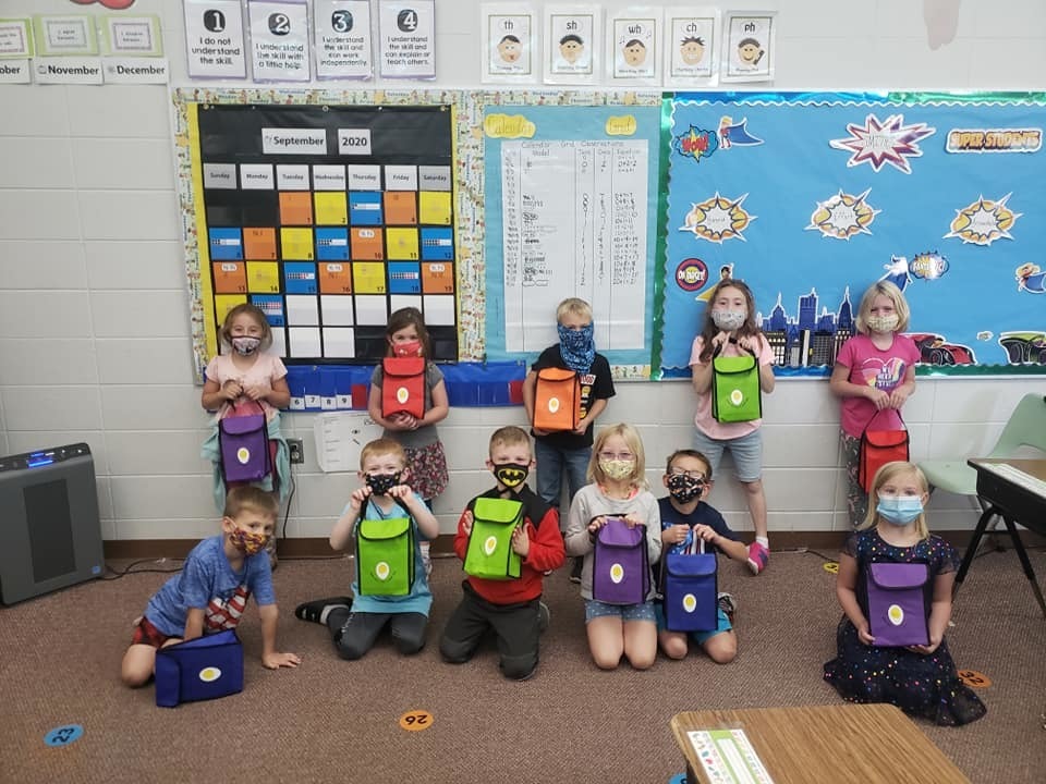 Saranac Elementary students posing with donated lunch boxes